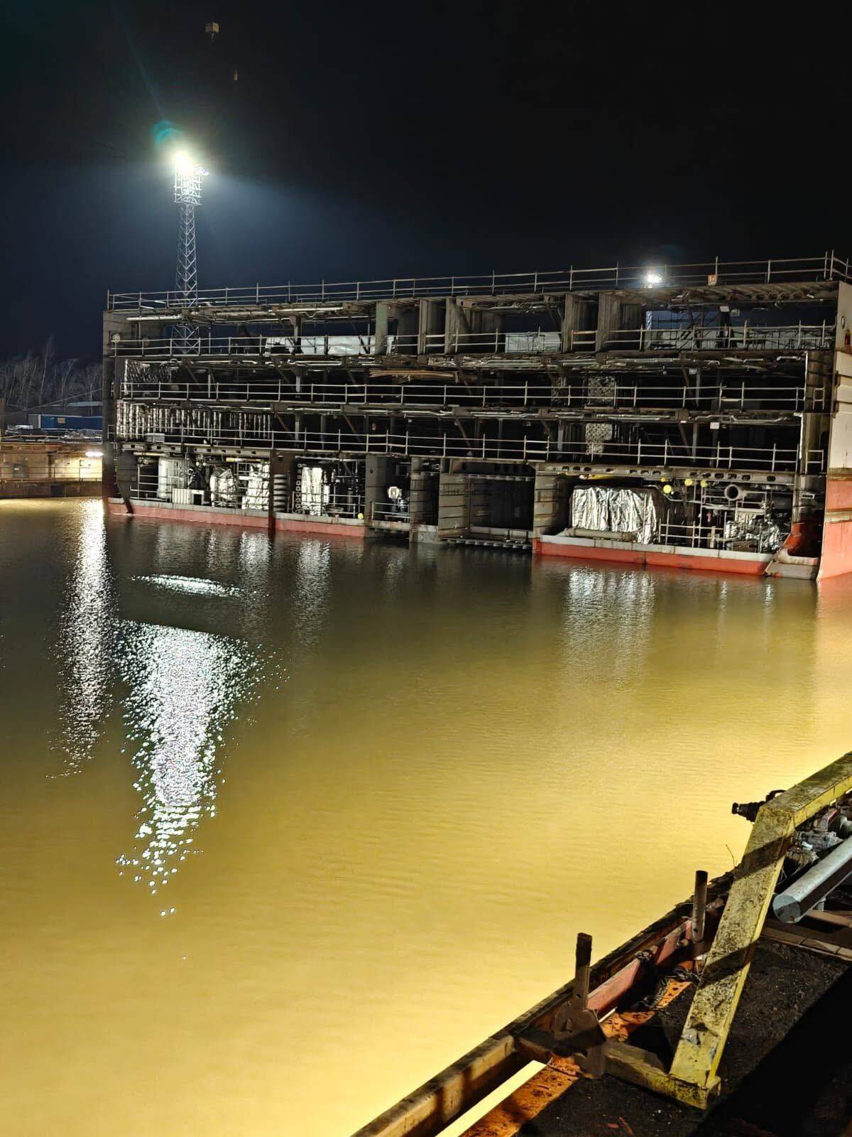 Cruise ship blocks in the flooded dock at night